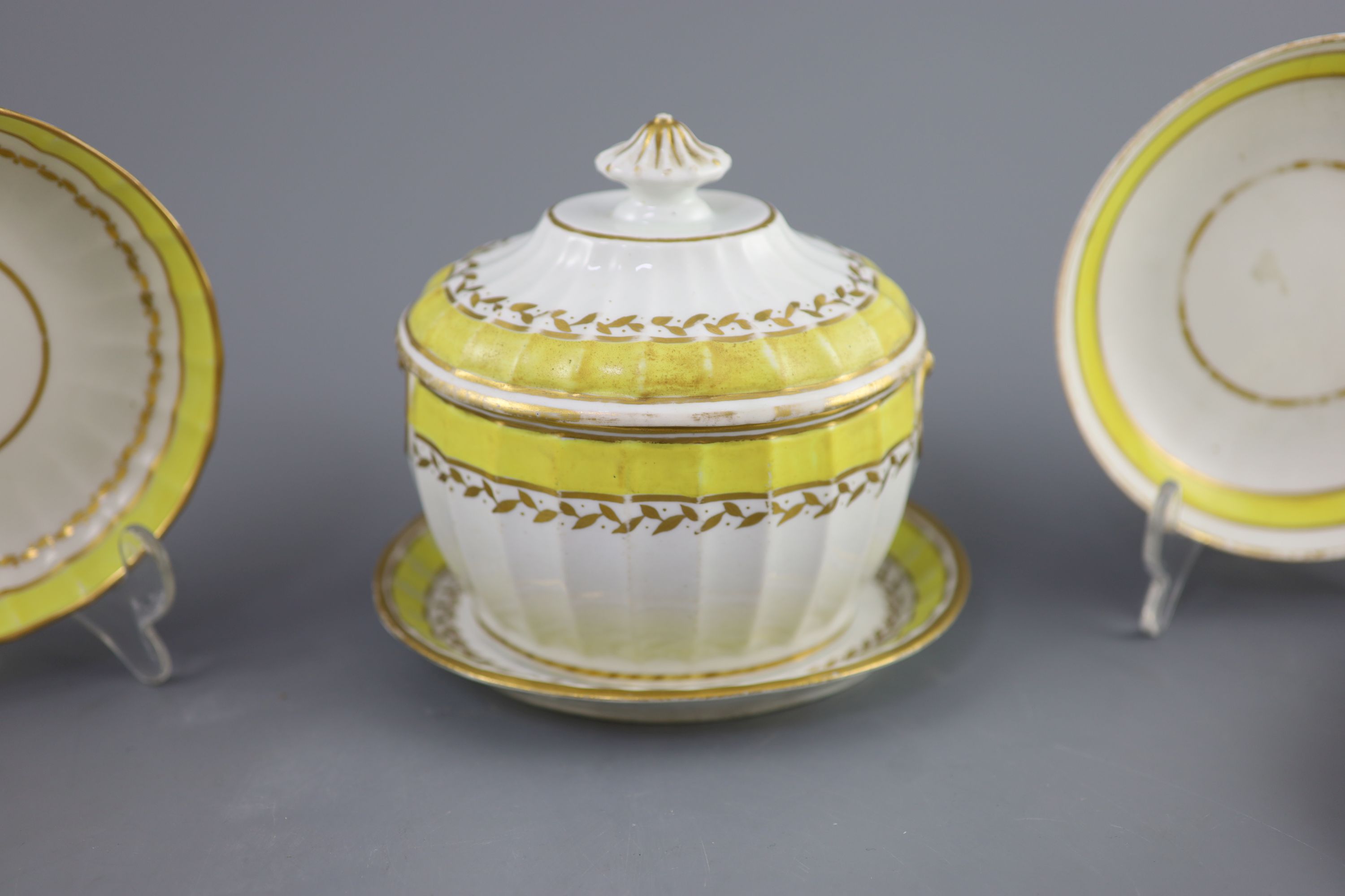 A group of Derby yellow ground tea and coffee wares and a chamberstick, c.1790-1800